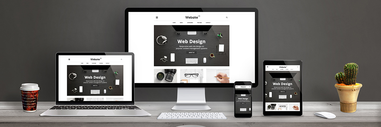 Smart office desk showing website design services template on multiple devices